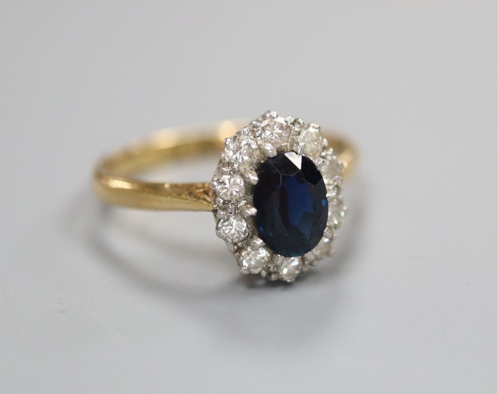 A diamond and sapphire ring, stamped 18ct & Plat, finger size L/M